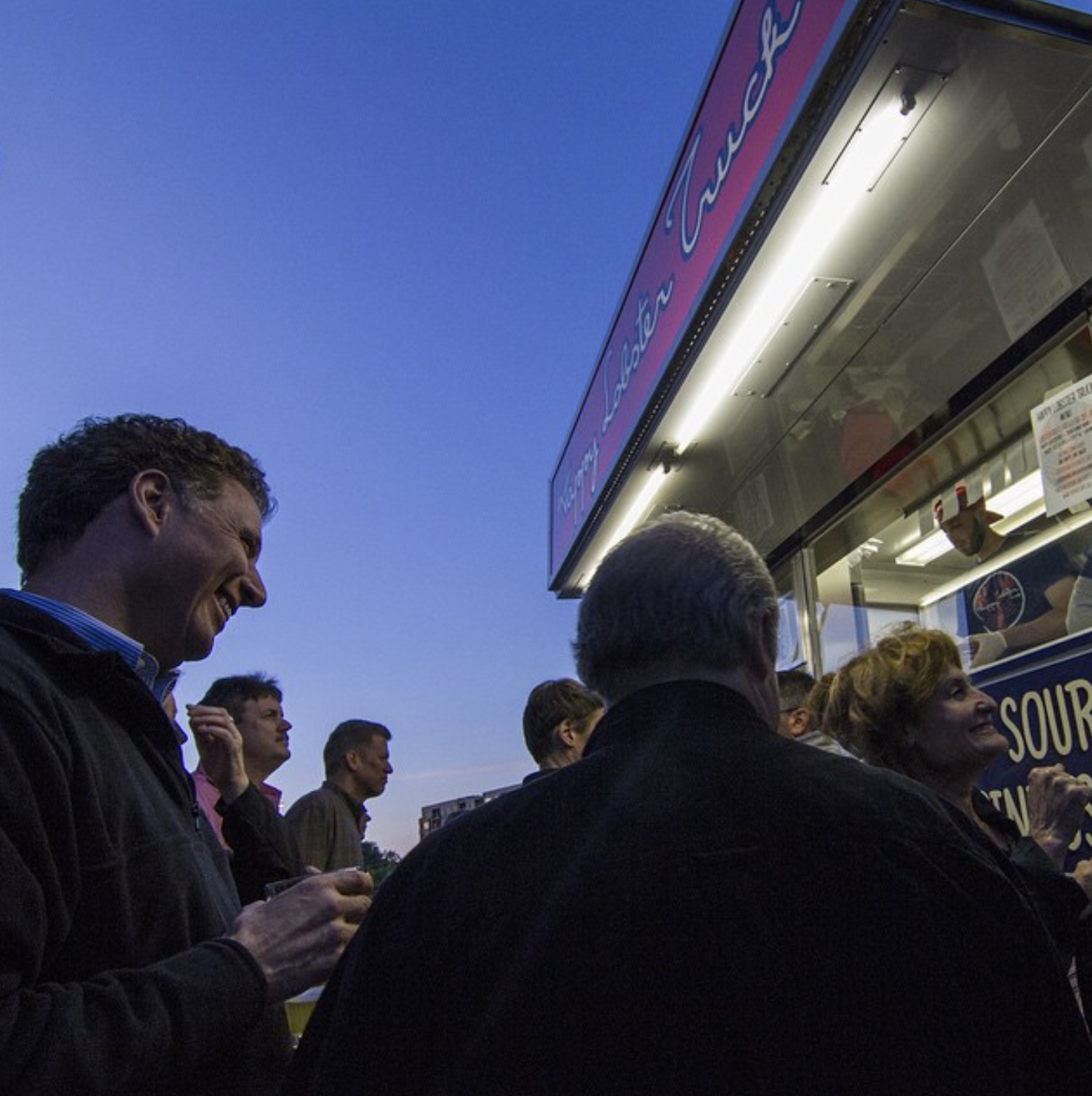A corporate event at the Happy Lobster Truck at dusk