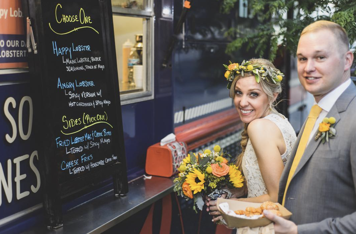 A couple at the Happy Lobster Truck on their wedding day